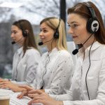 colleagues working together call center with headphones